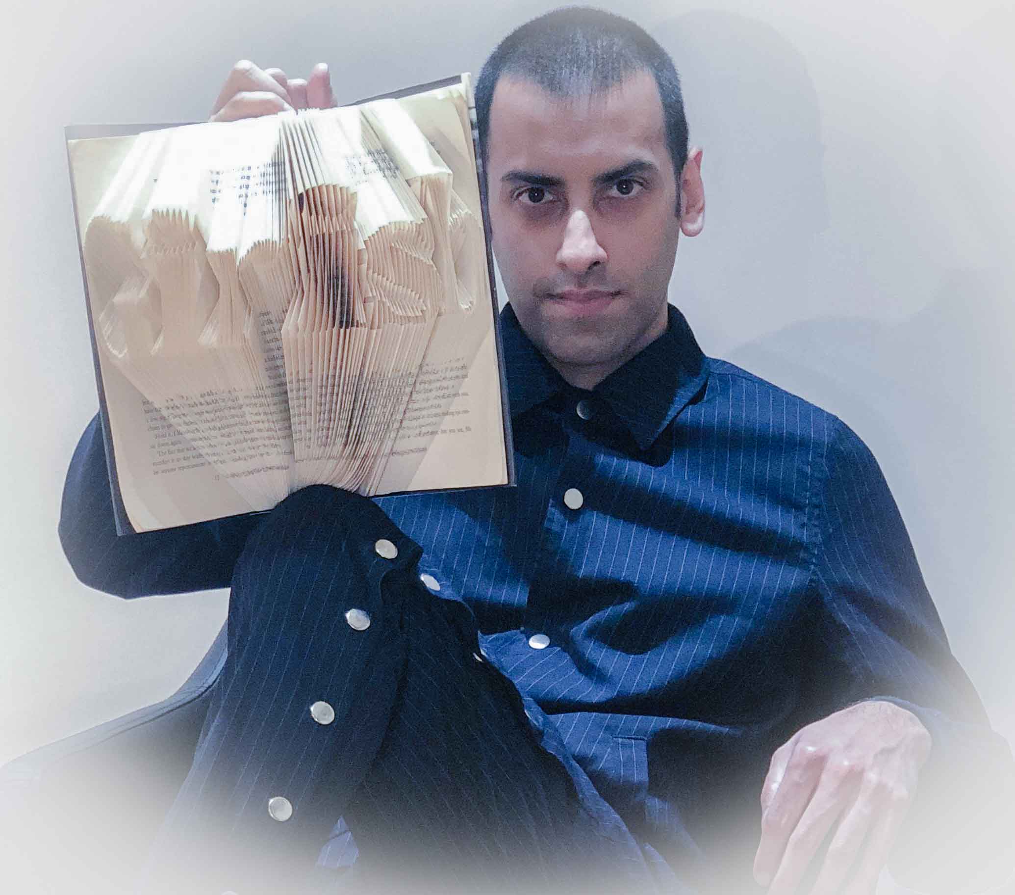 Dressed elegantly in pin stripes whilst holding a bespoke and personalised book, which is made to spell 'Girish' from its pages. It is like a piece of art